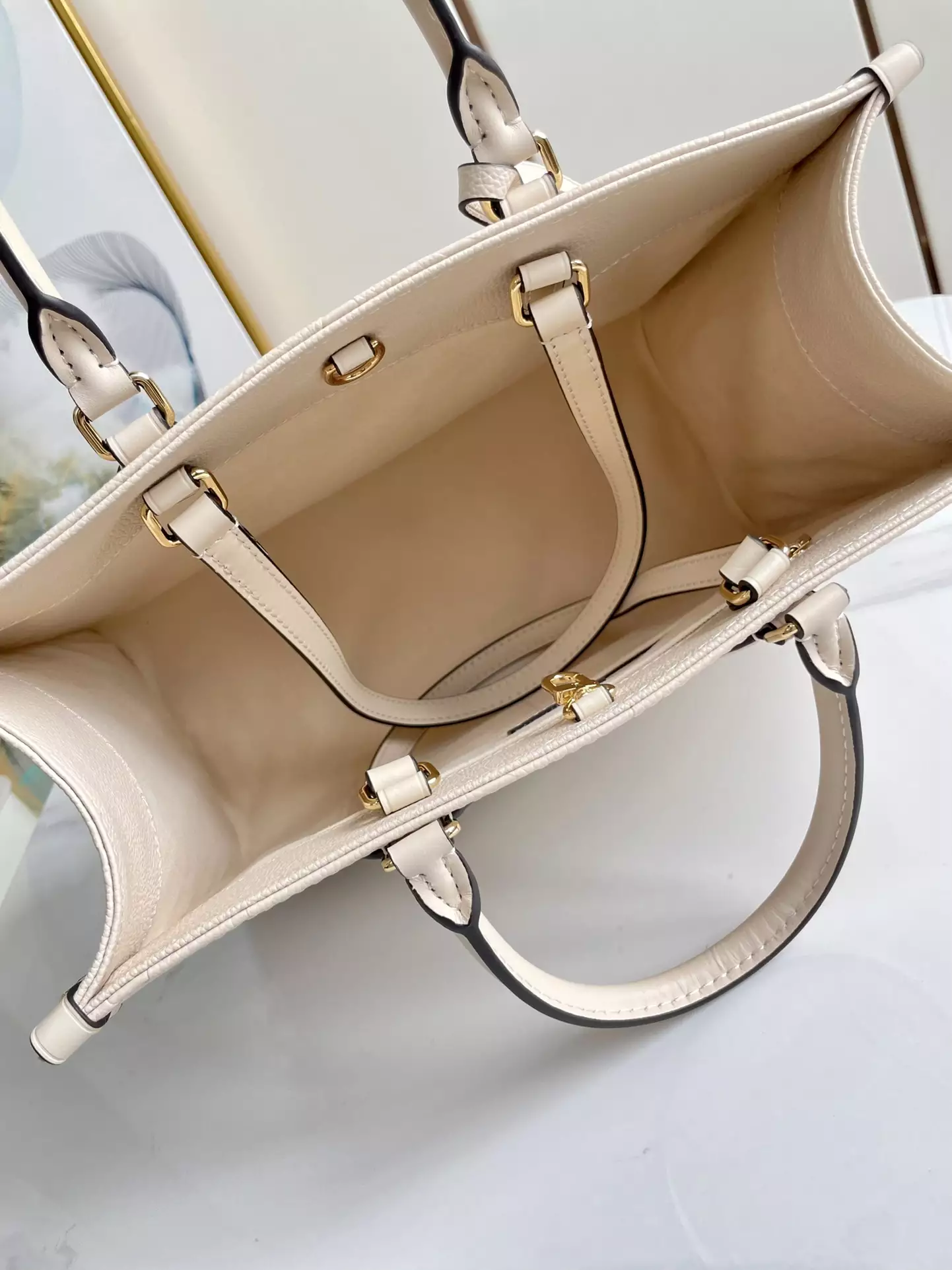 OnTheGo MM Monogram Empreinte Cream Leather