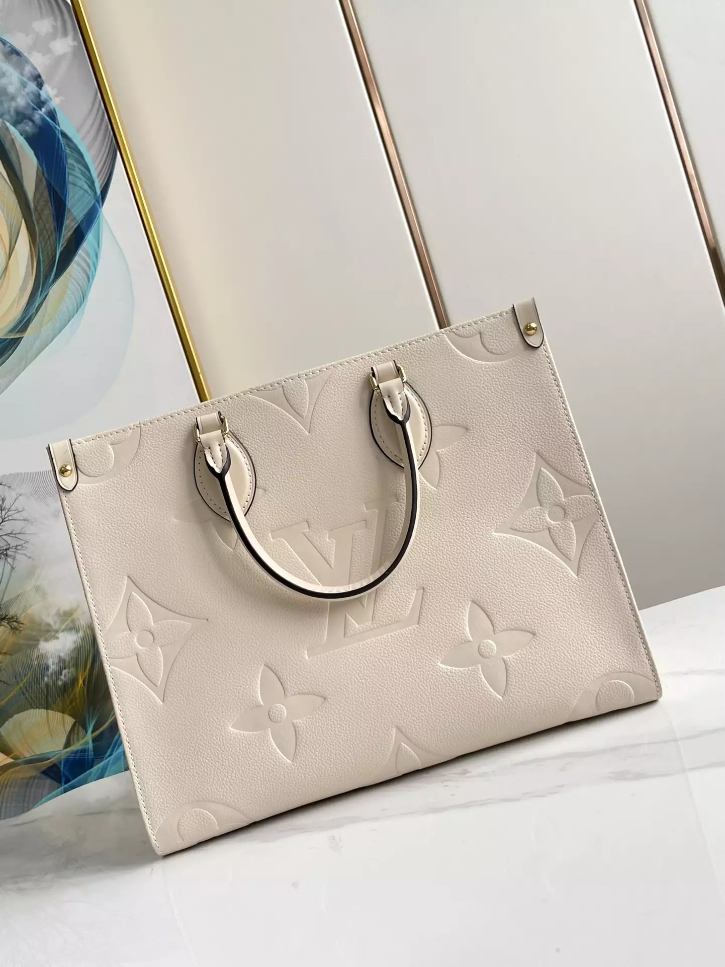 OnTheGo MM Monogram Empreinte Cream Leather