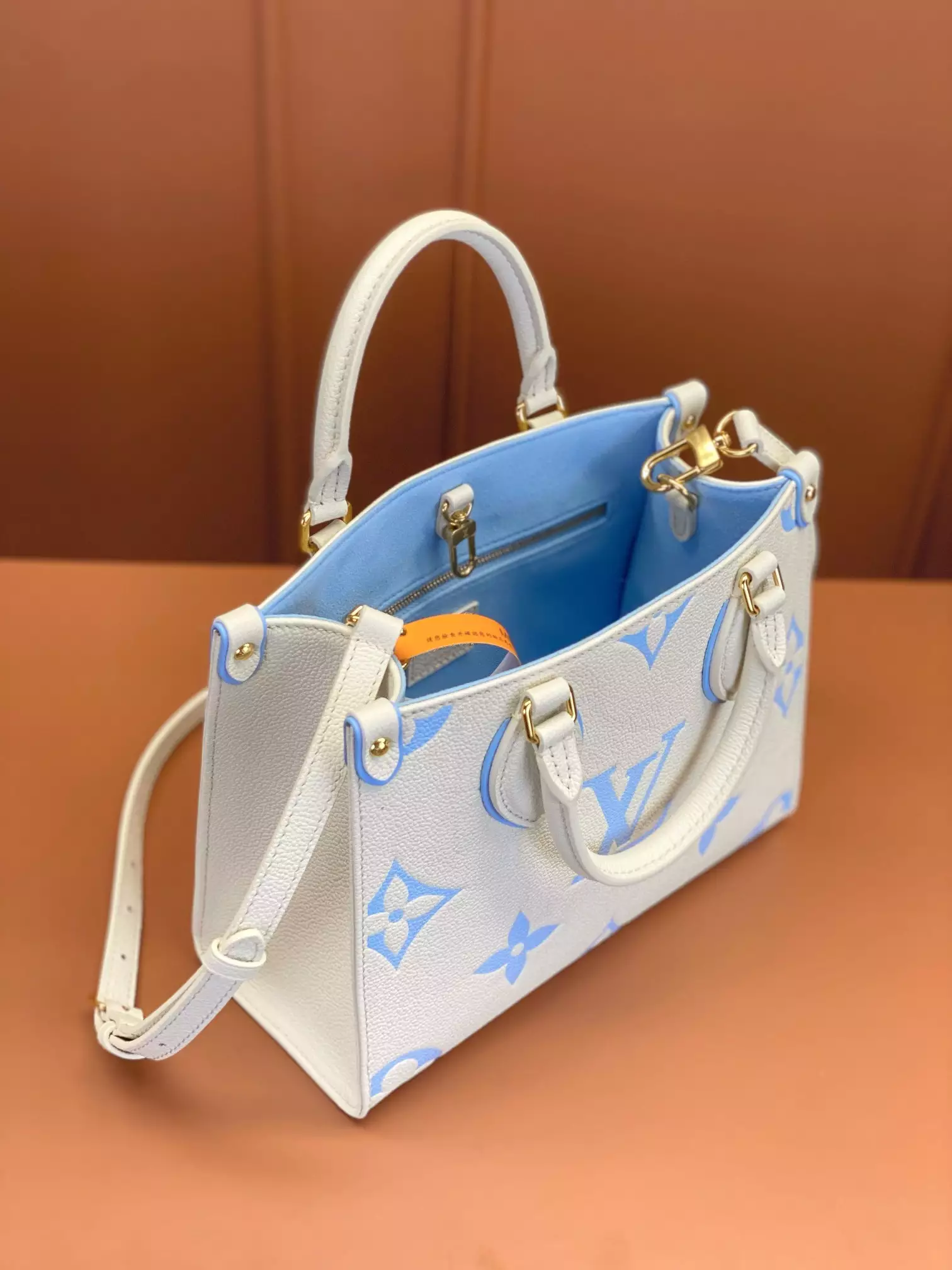 OnTheGo PM Bicolor Monogram Empreinte Latte/Candy Blue Leather