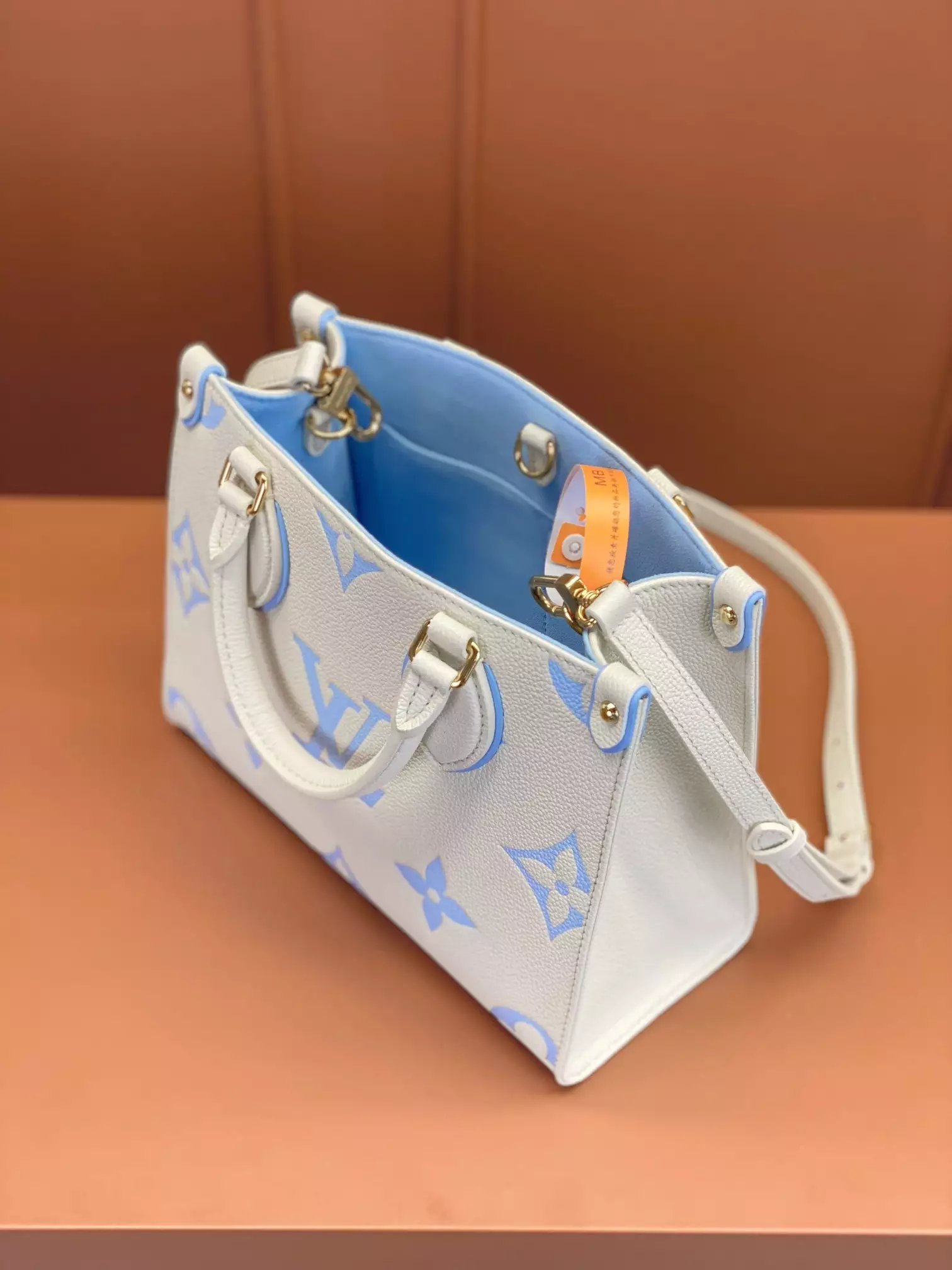 OnTheGo PM Bicolor Monogram Empreinte Latte/Candy Blue Leather