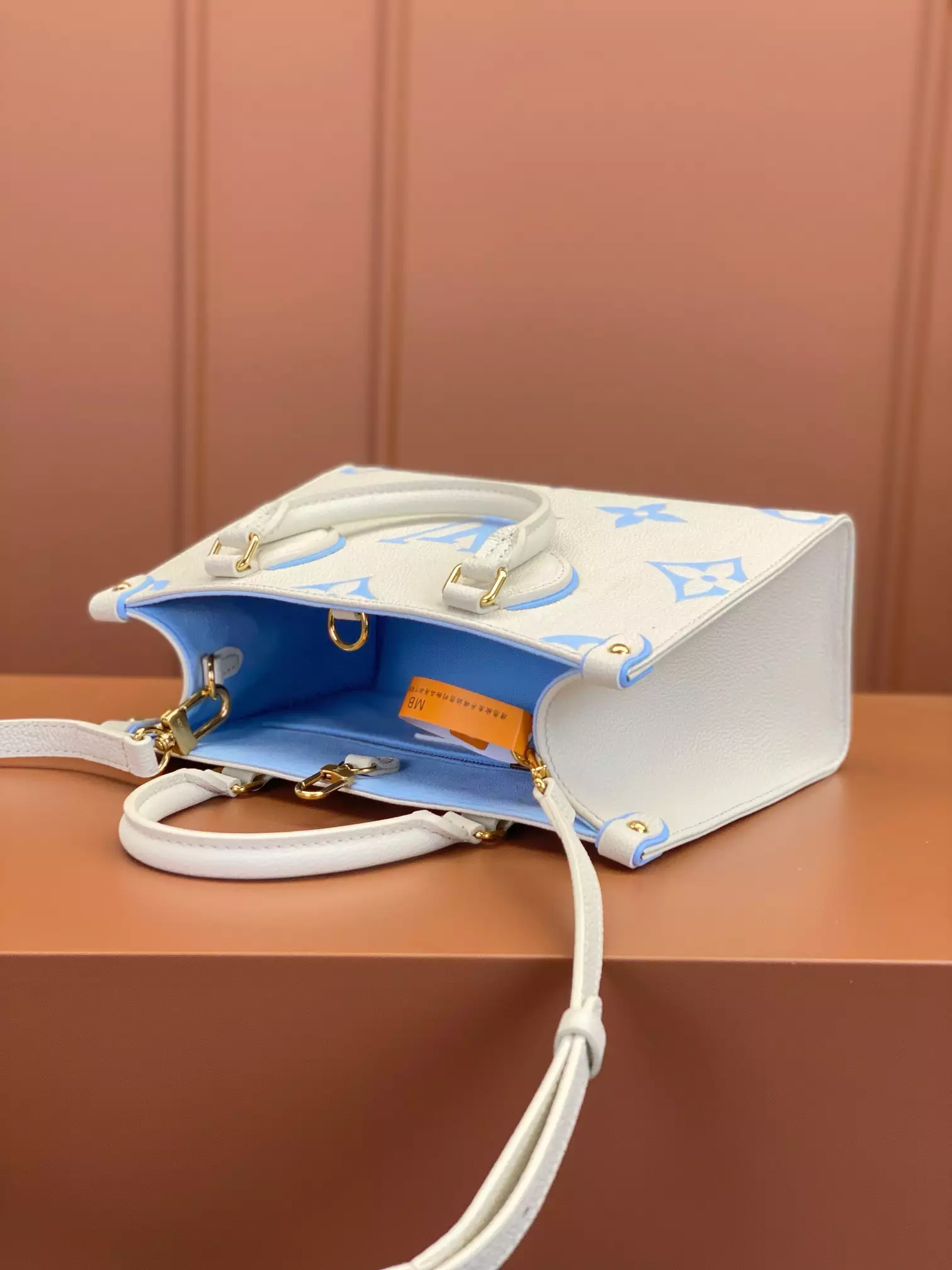 OnTheGo PM Bicolor Monogram Empreinte Latte/Candy Blue Leather